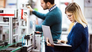 Young students of electronics working on project