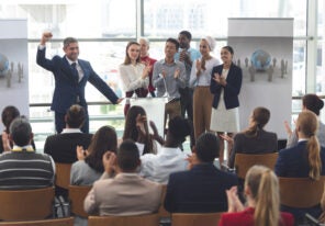 a diverse group of people giving a presentation