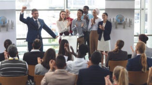 a diverse group of people giving a presentation