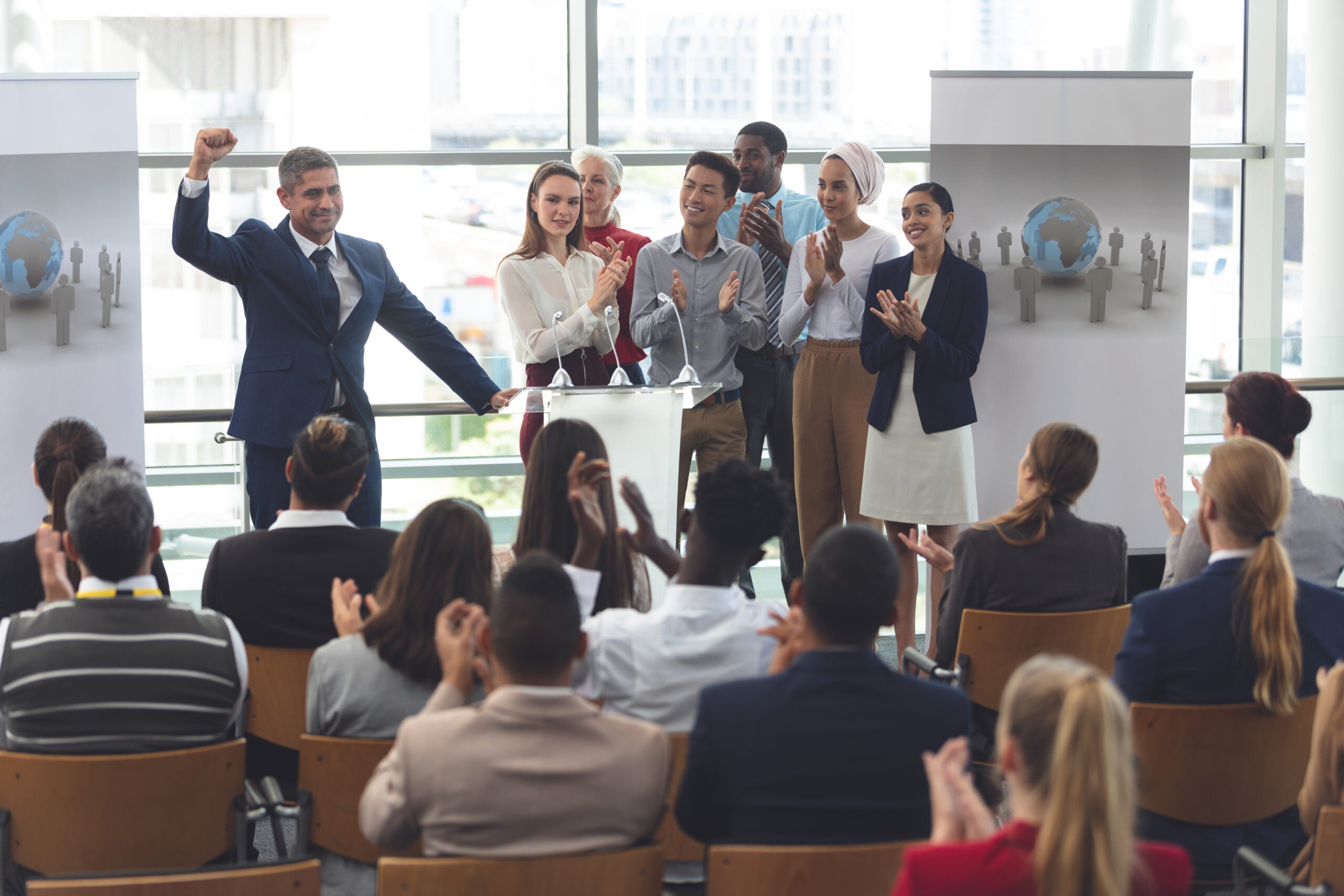 a diverse group of people giving a presentation