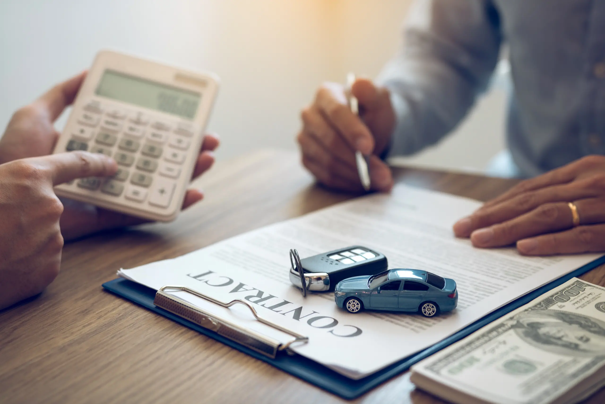 Finance manager of the car showroom is calculating the cost of reserving a new car for the customer while signing a car purchase contract.