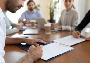 people signing the papers to purchase a franchise