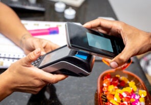 a man paying via contactless payments in mobile phone