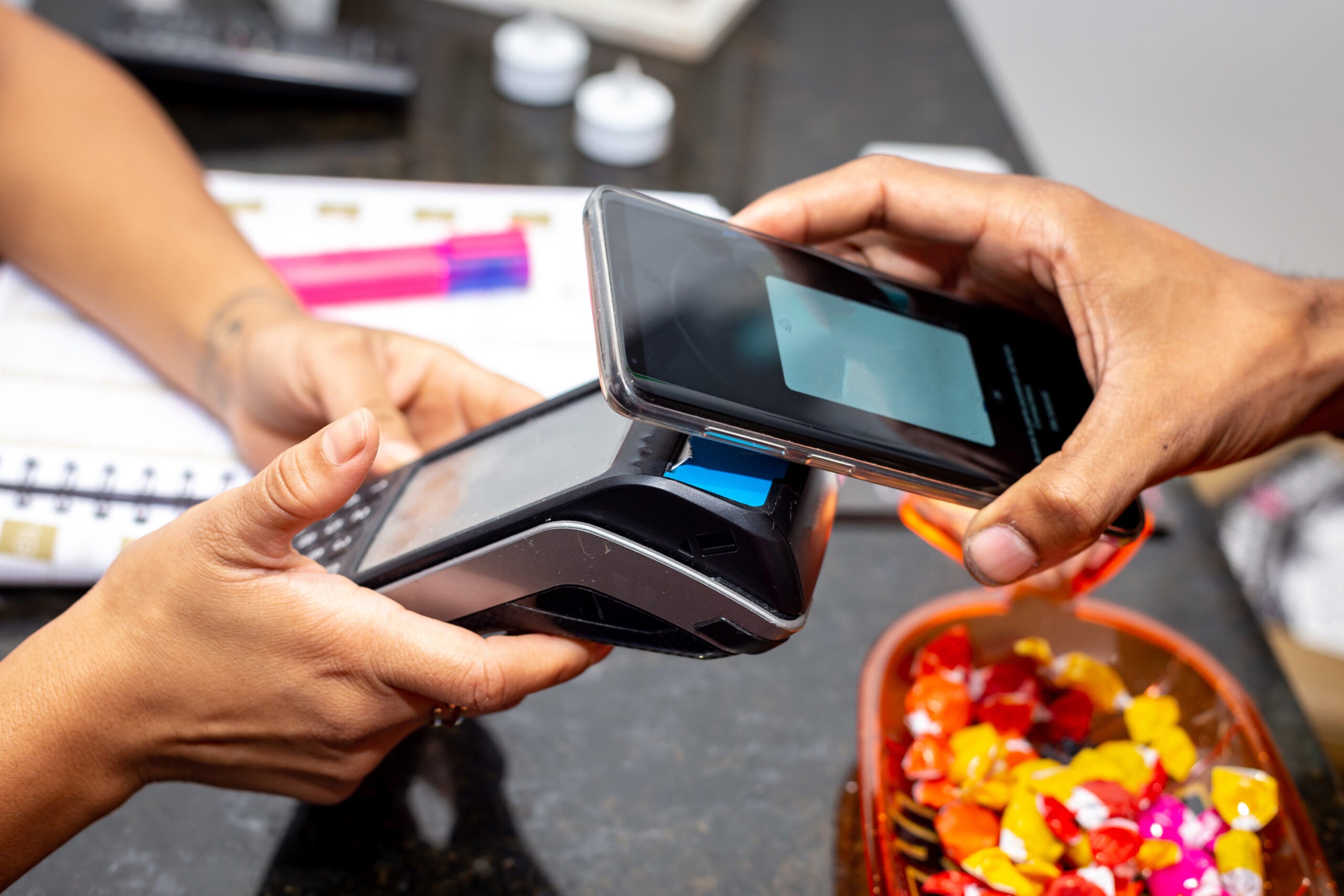 a man paying via contactless payments in mobile phone