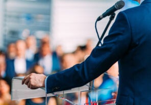 a person giving a speech from a podium