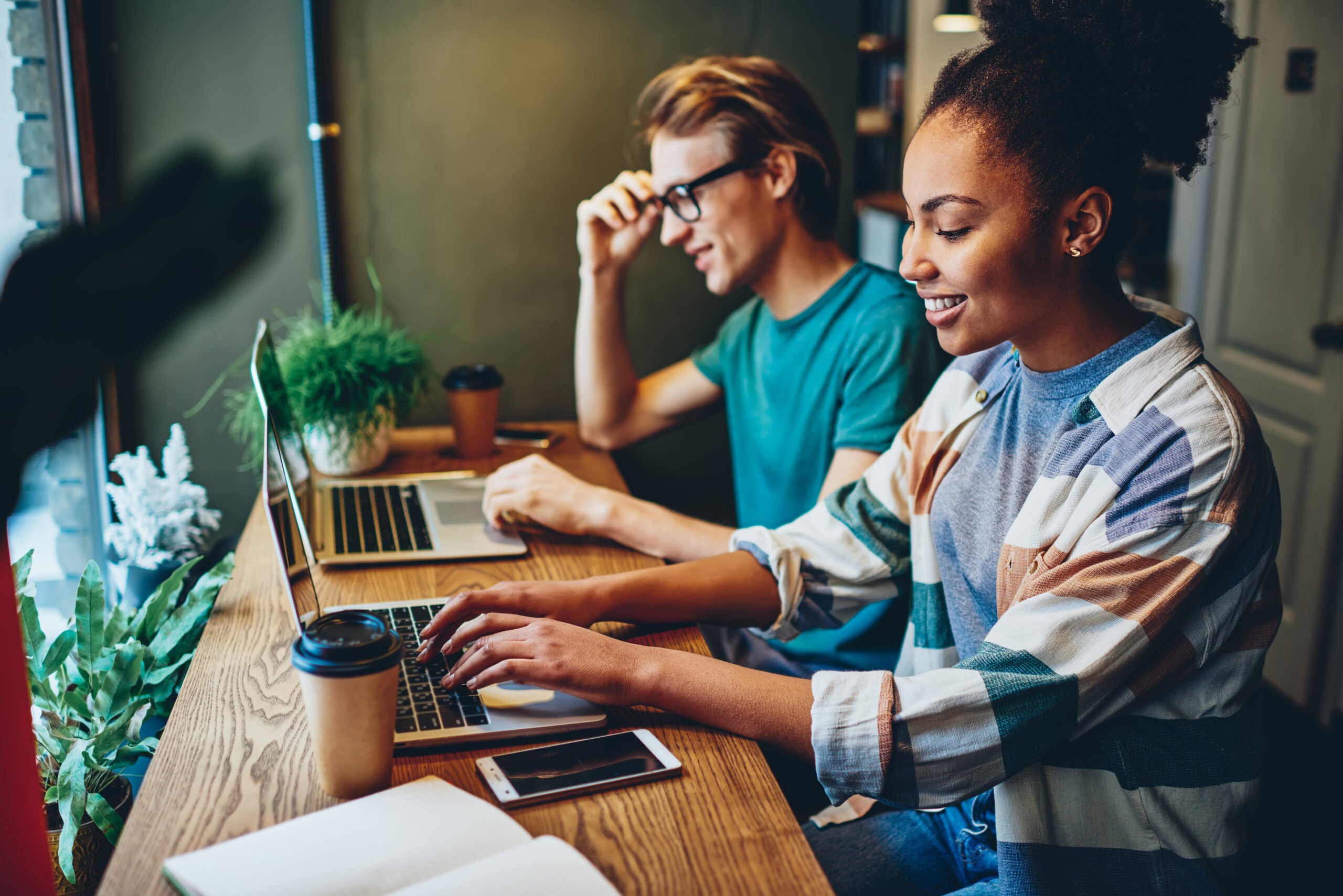 Man and woman blogging on laptops