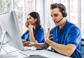 A Group of happy call center employees smiling and providing helpful service