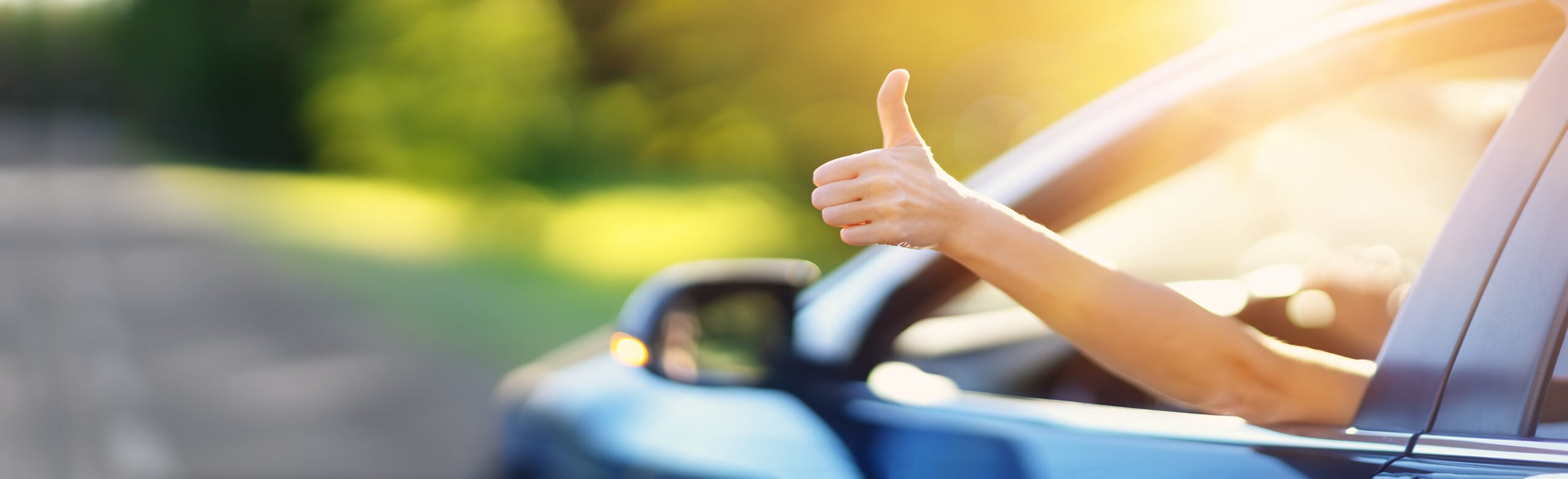 a thumbs up outside of a car window