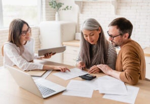 a photo of people signing insurance documents