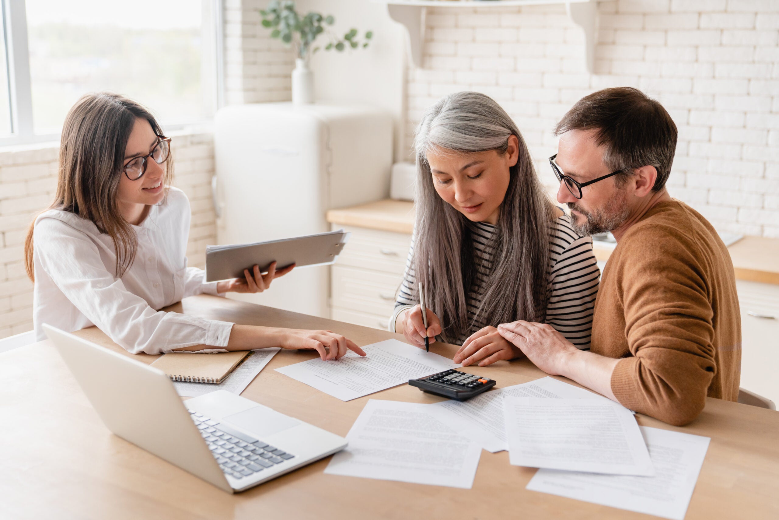 a photo of people signing insurance documents