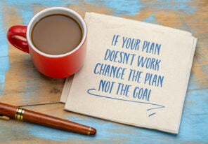 a coffee, a pen, and a napkin with the words "If your plan doesn't work, change the plan not the goal"