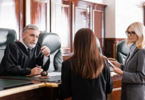 a judge listens to two lawyers