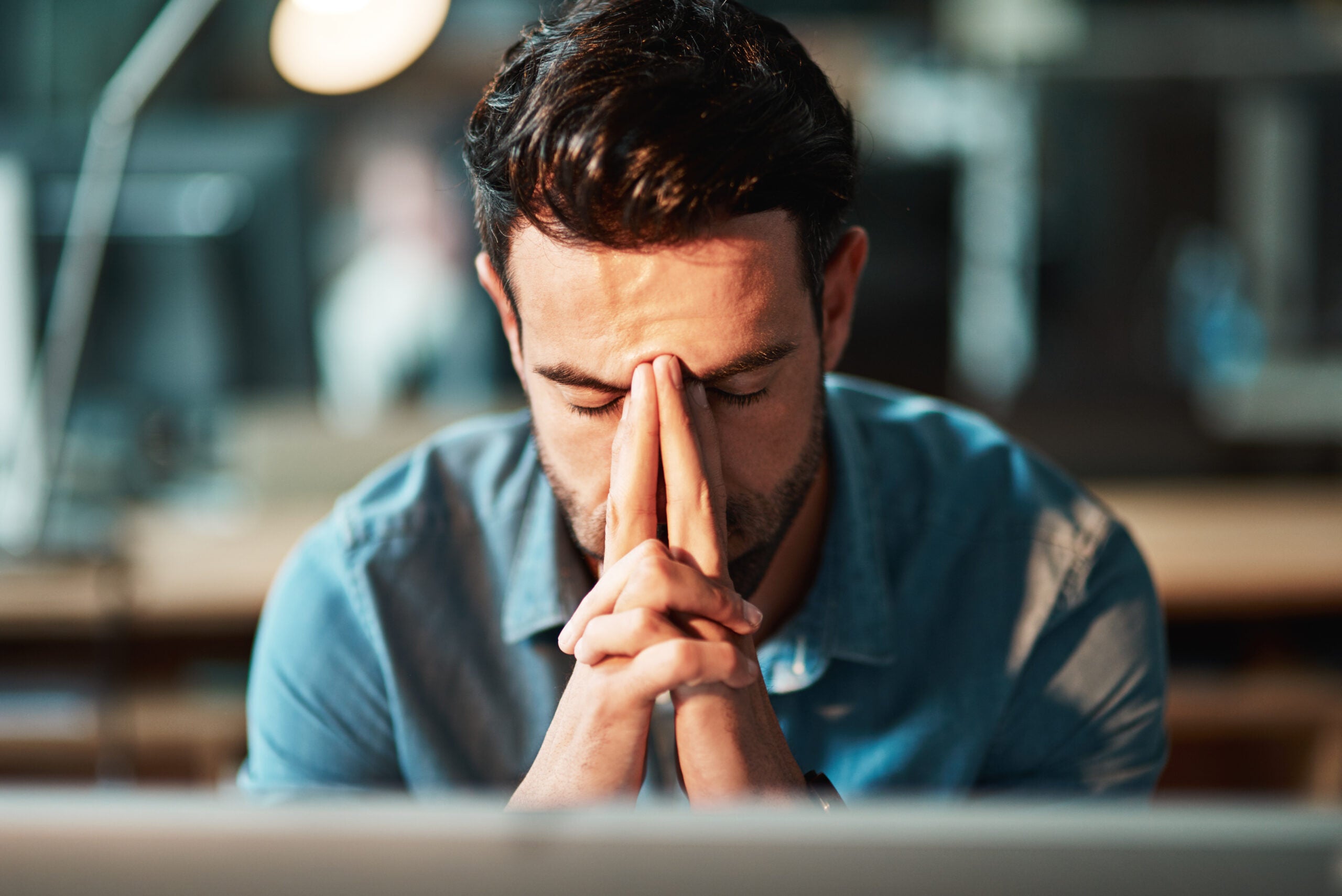 a business owner in distress with their hands in front of their face