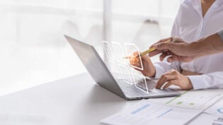 two people analyzing data from reports together