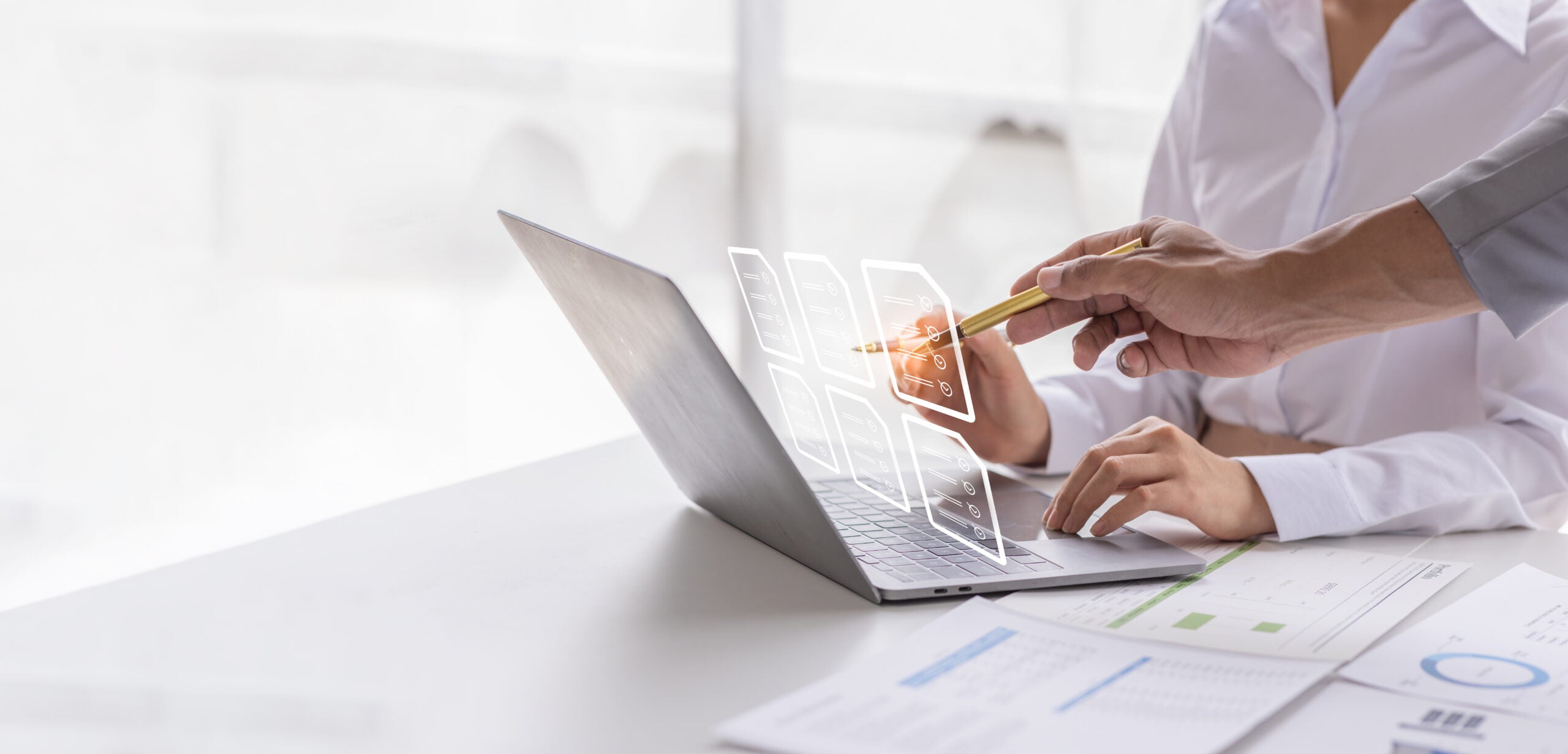 two people analyzing data from reports together