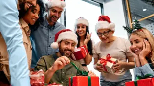 a team opening gifts at the office