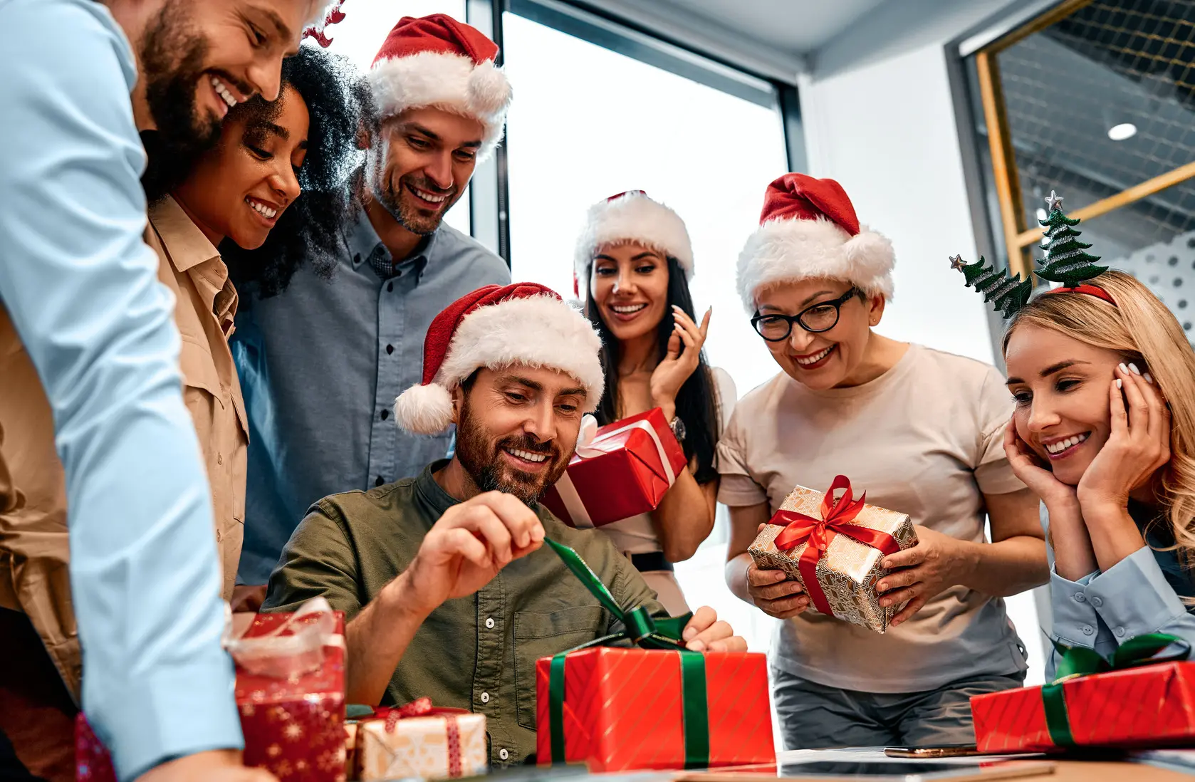 a team opening gifts at the office