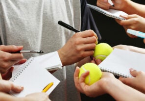 an athlete signing autographs