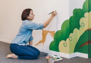 an artist working on a mural