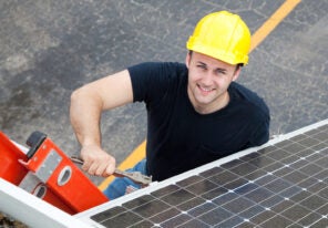 worker installing solar panels