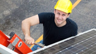 worker installing solar panels