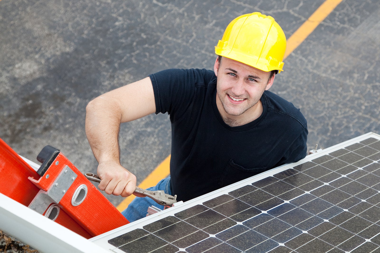 worker installing solar panels