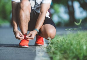 a runner tying their shoe