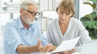 an older man and woman planning for retirement