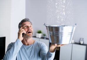 using a bucket to catch water from a leak