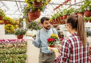 a floral business owner aiding an employee