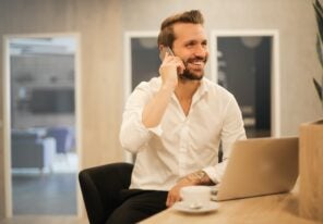 a business owner smiling on the phone