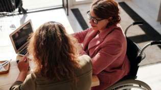 a woman speaking with her lawyer