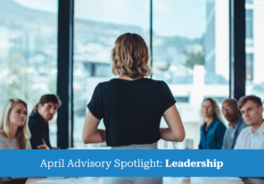 Business women standing in front of table giving presentation to colleagues