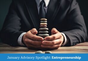 a business person holding rocks of various sizes