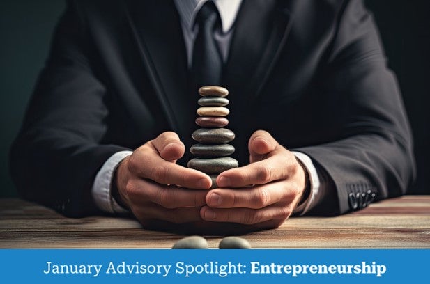 a business person holding rocks of various sizes